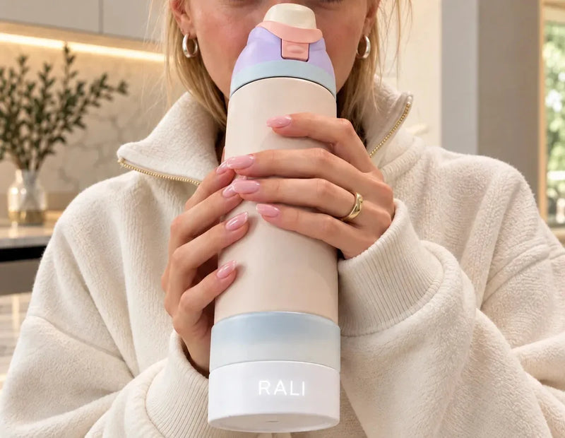 Woman drinking from her Owala FreeSip 24 oz on the RALI Base